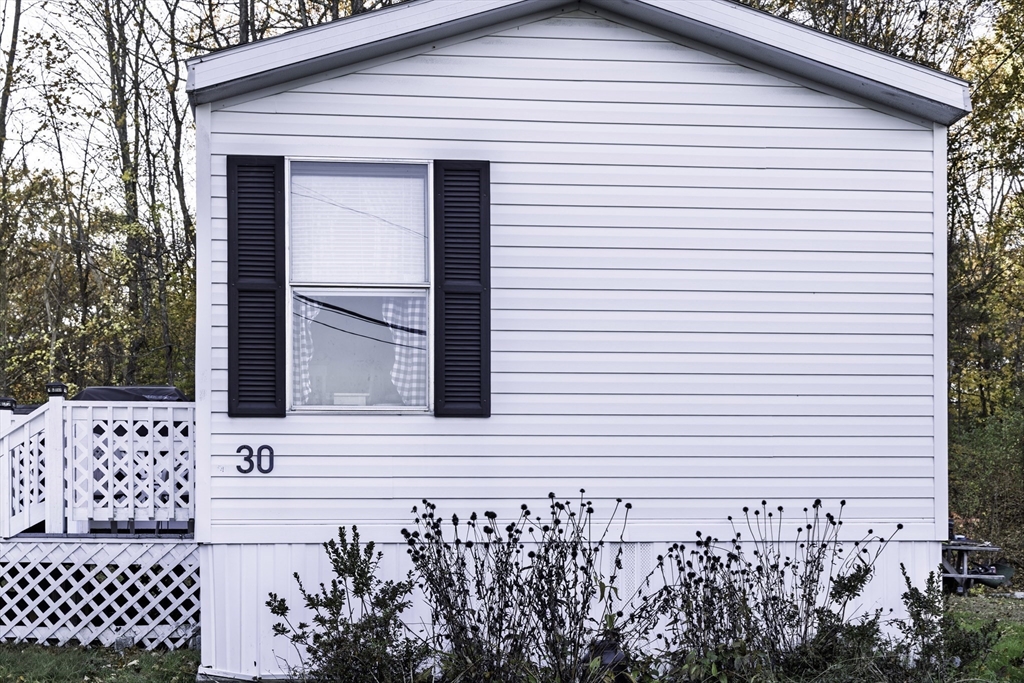 18 Maple Street, Unit 30 Pepperell, MA 01463 - Photo 18 of 19 a front view of a house with a garden