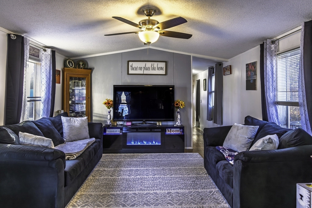 18 Maple Street, Unit 30 Pepperell, MA 01463 - Photo 2 of 19 a living room with furniture and a flat screen tv