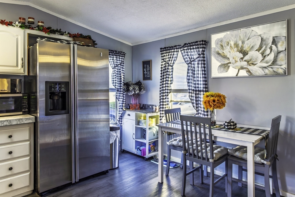 18 Maple Street, Unit 30 Pepperell, MA 01463 - Photo 5 of 19 a view of a dining room with furniture window and wooden floor