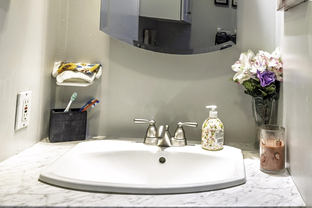 18 Maple Street, Unit 30 Pepperell, MA 01463 - Photo 9 of 19 a bathroom sink with a mirror