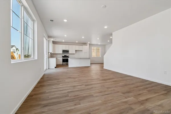 a view of kitchen and kitchen with wooden floor