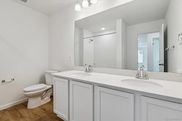 a bathroom with a sink toilet and mirror
