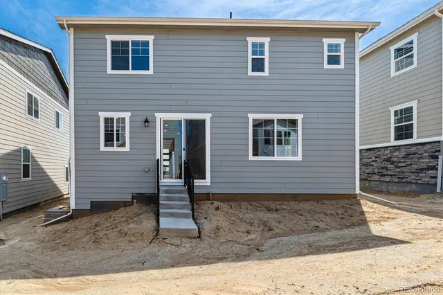 a view of a house with wooden fence