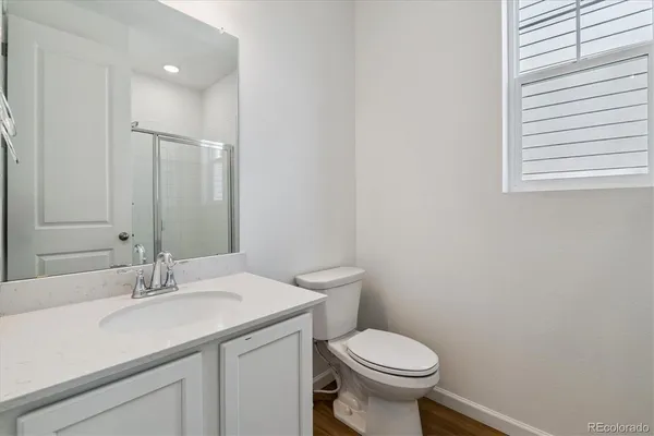a bathroom with a sink toilet and a mirror