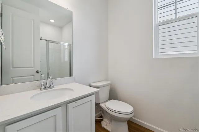 a bathroom with a sink toilet and a mirror