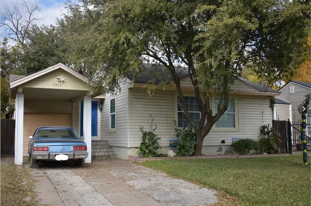 a view of a car parked in front of a house