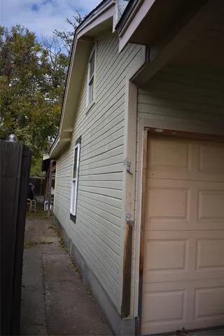 a view of a house with a door and wooden walls