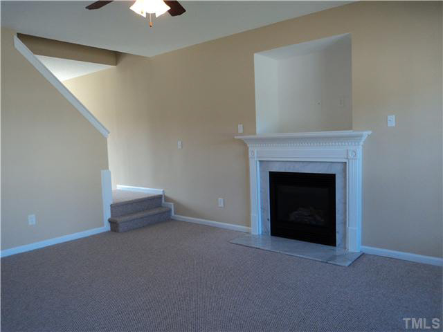 6822 Paint Rock Lane Raleigh, NC 27610 - Photo 3 of 11 a view of an empty room with a fireplace