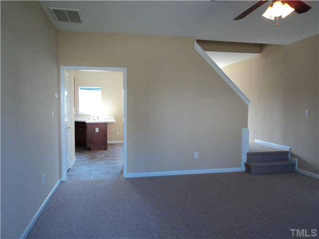 6822 Paint Rock Lane Raleigh, NC 27610 - Photo 4 of 11 a view of an empty room with a ceiling fan and closet area