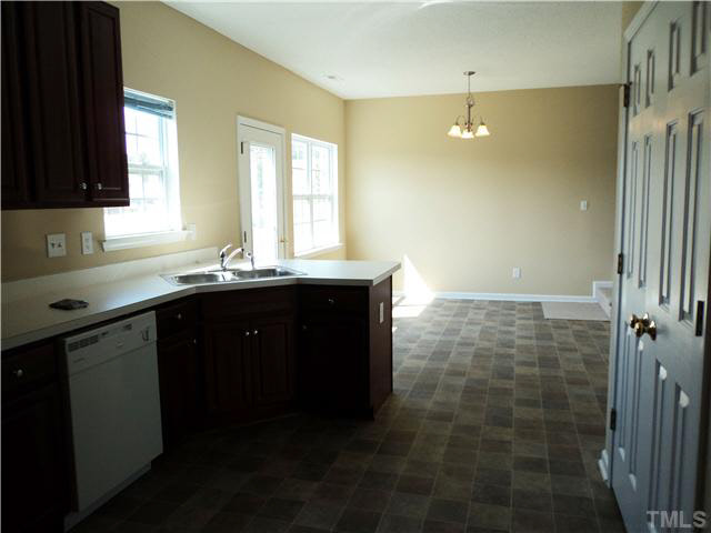 6822 Paint Rock Lane Raleigh, NC 27610 - Photo 5 of 11 a bathroom with a granite countertop sink a mirror and a shower