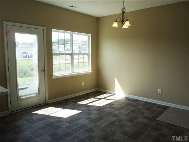 6822 Paint Rock Lane Raleigh, NC 27610 - Photo 6 of 11 an empty room with windows and fan