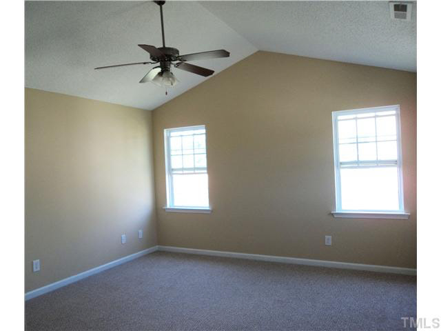 6822 Paint Rock Lane Raleigh, NC 27610 - Photo 7 of 11 an empty room with a window and a fan