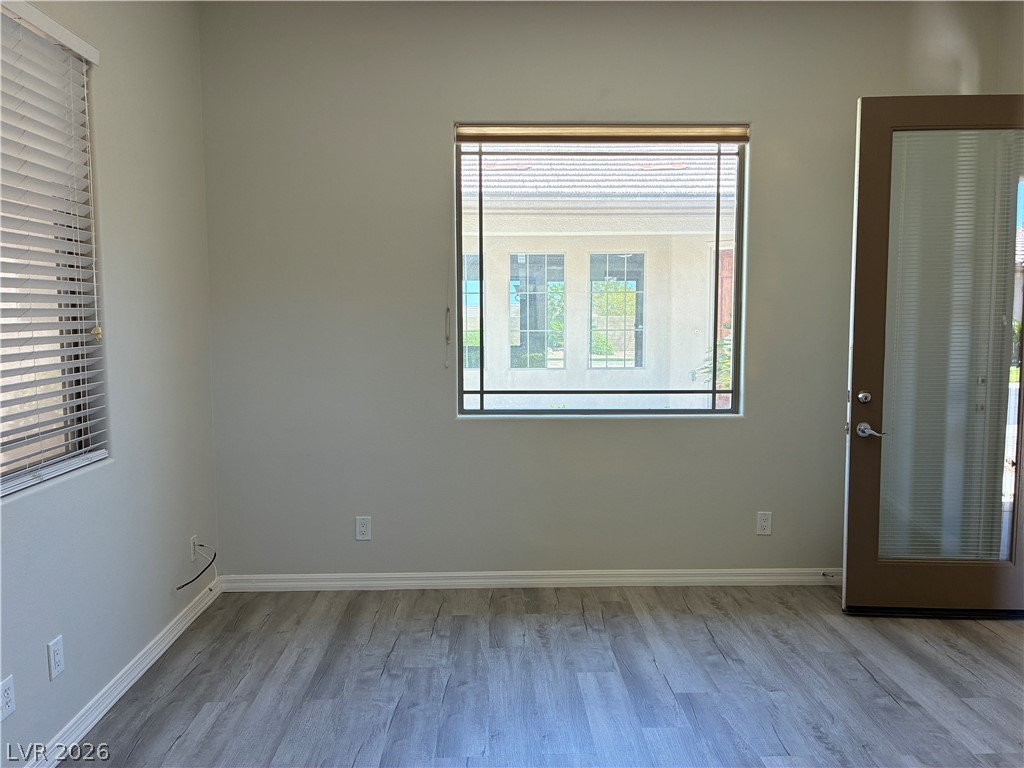 10 Caprington Road Henderson, NV 89052 - Photo 32 of 44 Newly installed laminate wood flooring sets a fresh foundation for this adaptable living area.
