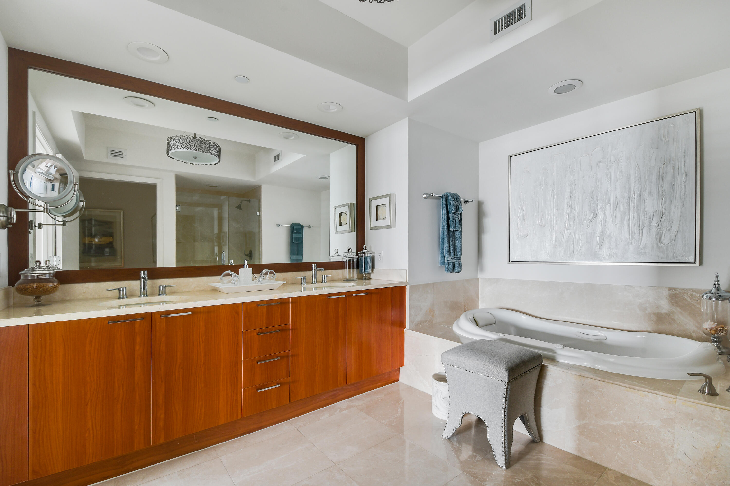 2650 Lake Shore Drive, Unit 1203 Riviera Beach, FL 33404 - Photo 13 of 17 a bathroom with a sink and a large mirror