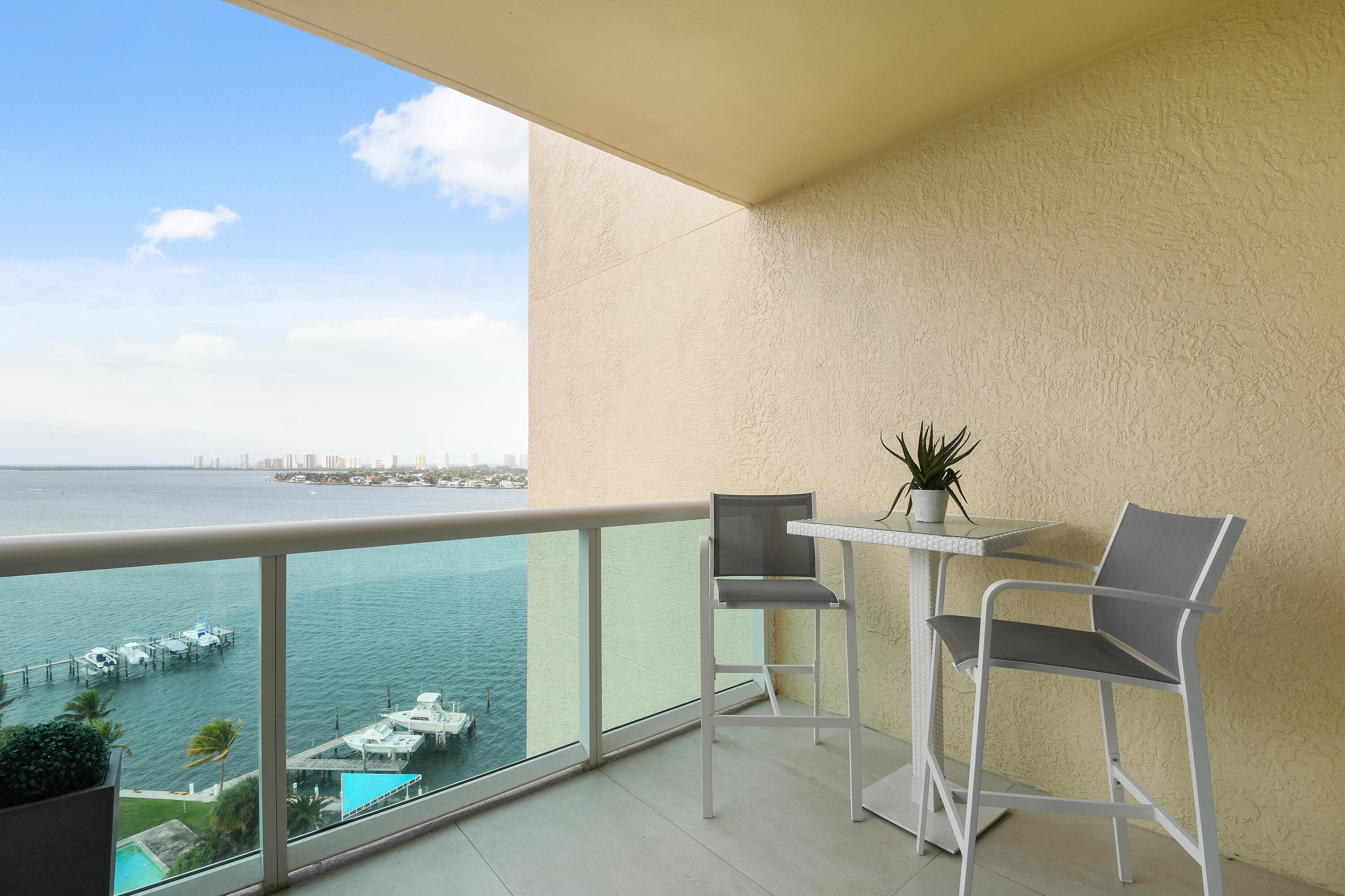 2650 Lake Shore Drive, Unit 1203 Riviera Beach, FL 33404 - Photo 15 of 17 a view of an chairs and table in the balcony
