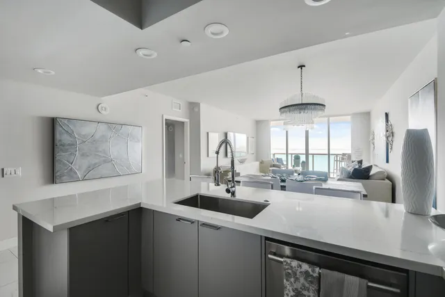 a kitchen with stainless steel appliances a sink and a refrigerator