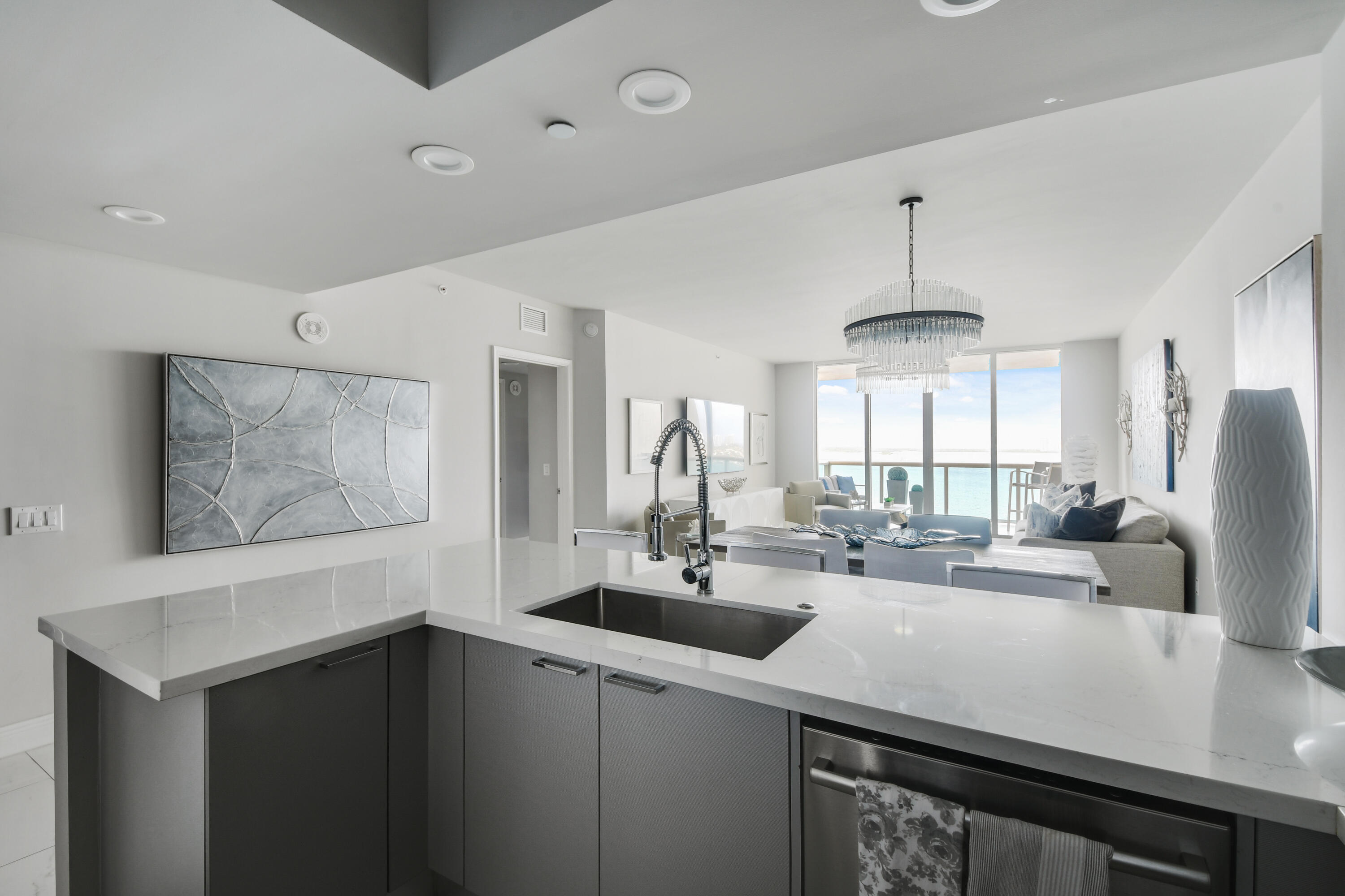 2650 Lake Shore Drive, Unit 1203 Riviera Beach, FL 33404 - Photo 4 of 17 a kitchen with stainless steel appliances a sink and a refrigerator