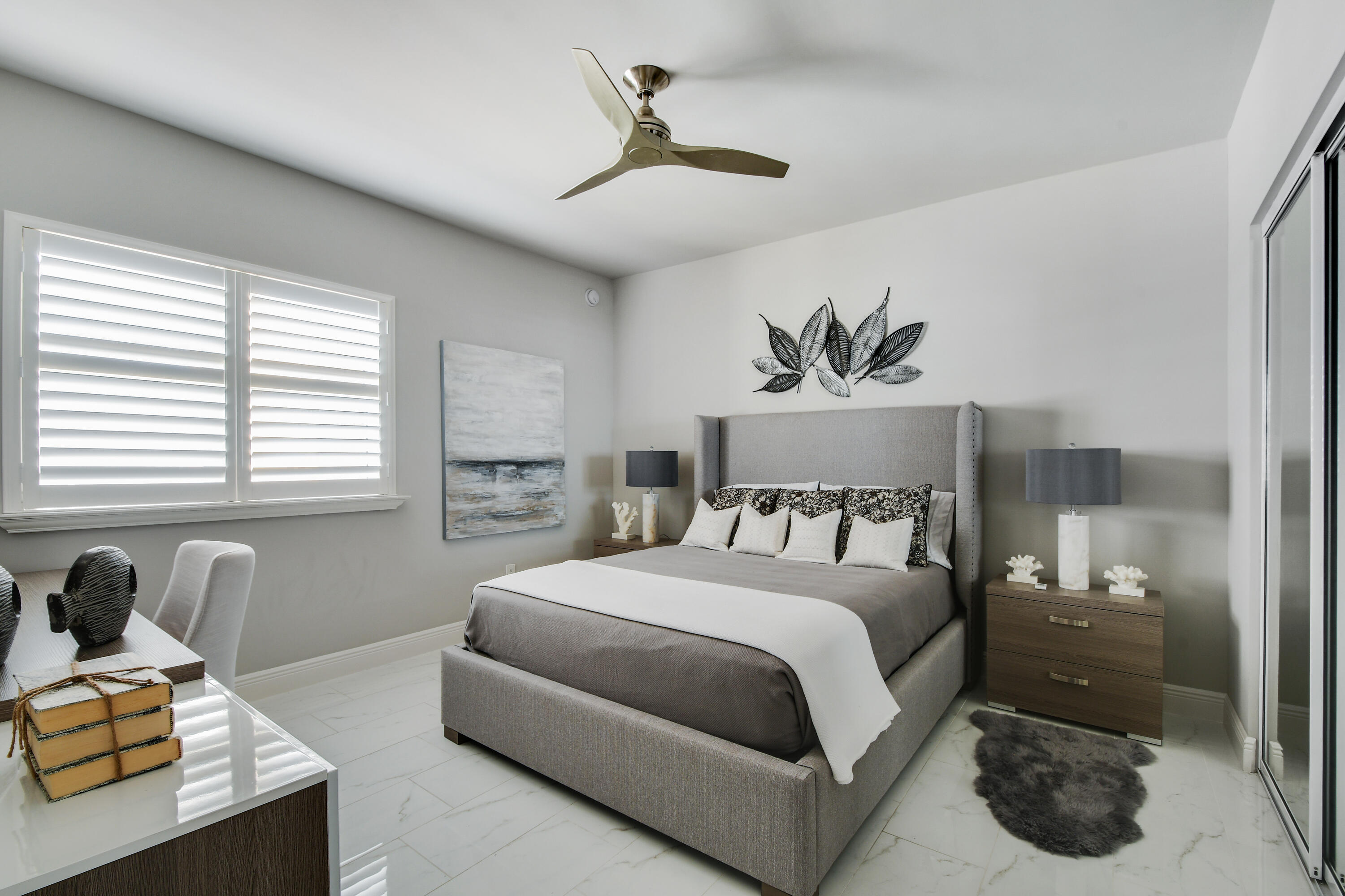 2650 Lake Shore Drive, Unit 1203 Riviera Beach, FL 33404 - Photo 7 of 17 a bedroom with a bed and a chandelier