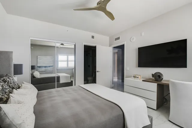 a bedroom with a bed and a flat screen tv