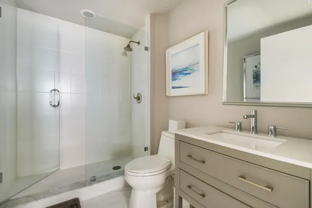 a bathroom with a sink toilet and shower