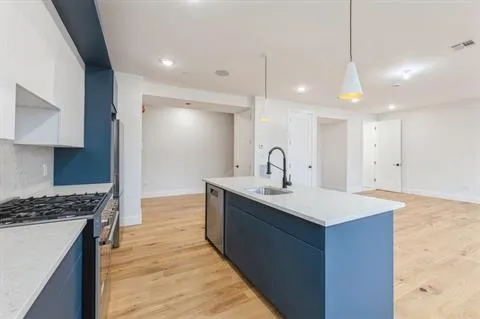 a kitchen with a sink a stove a refrigerator and a oven