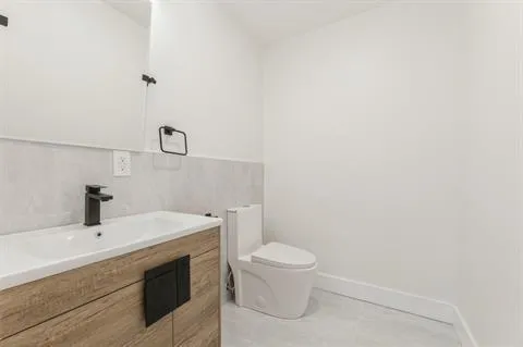 a bathroom with a sink a toilet and mirror