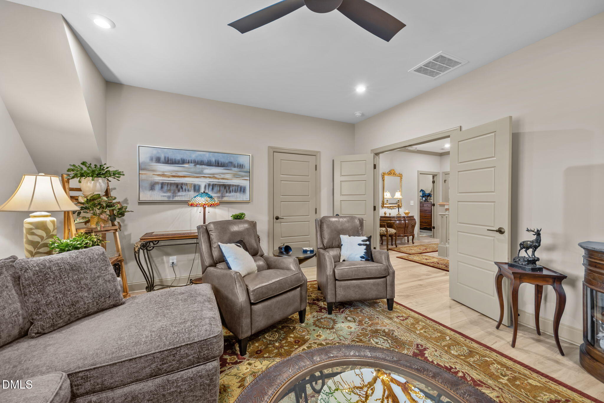 1748 Deacon Fls Way Wendell, NC 27591 - Photo 35 of 51 a living room with furniture and a chandelier