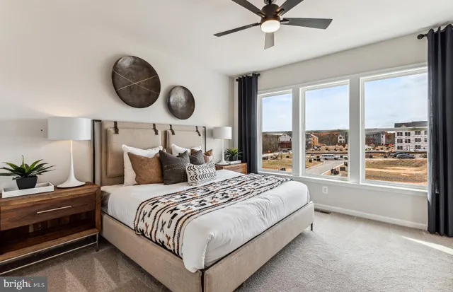 a bedroom with bed and a large window