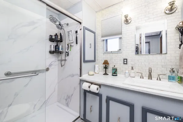 a bathroom with a sink double vanity and shower