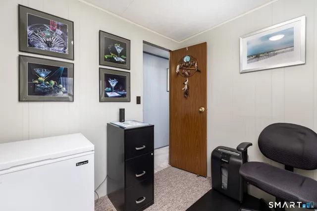 a living room with furniture and a baby crib