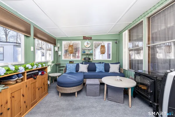 a living room with furniture a table and a large window