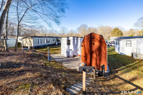 a backyard of a house with barbeque oven