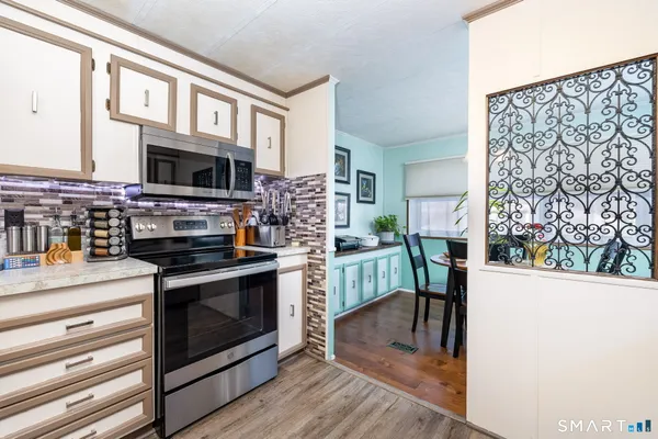 a kitchen with stainless steel appliances a stove a sink and a microwave