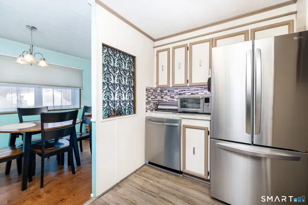 a kitchen with stainless steel appliances a refrigerator sink and cabinets