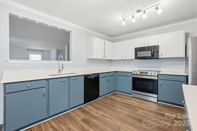 a kitchen with stainless steel appliances granite countertop a refrigerator and a sink