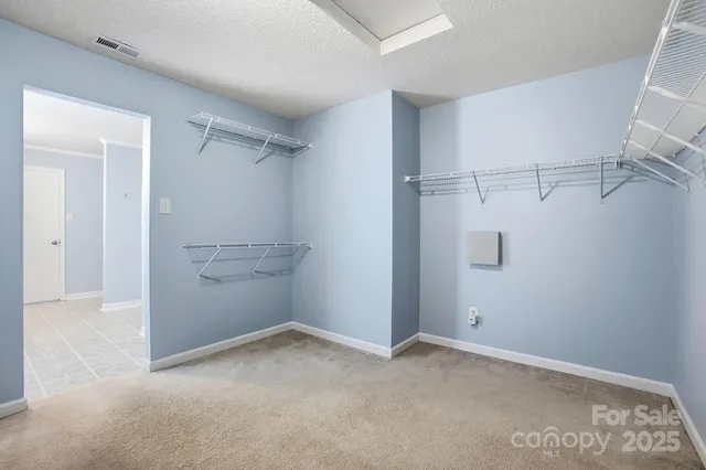 an empty room with a window and a ceiling fan