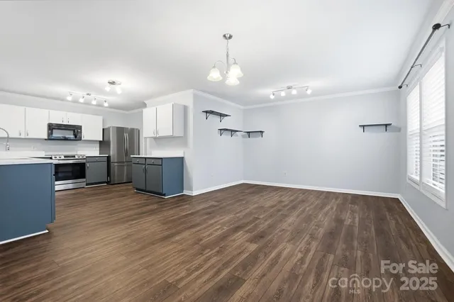 a view of kitchen with wooden floor and window