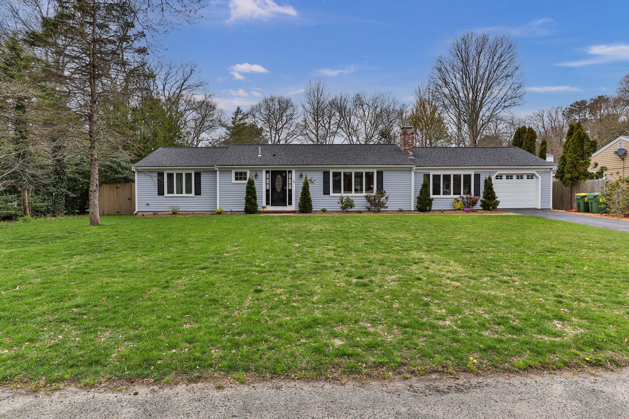 159 Sheaffer Road Centerville, MA 02632 - Photo 1 of 29 a view of a house with a big yard and large trees