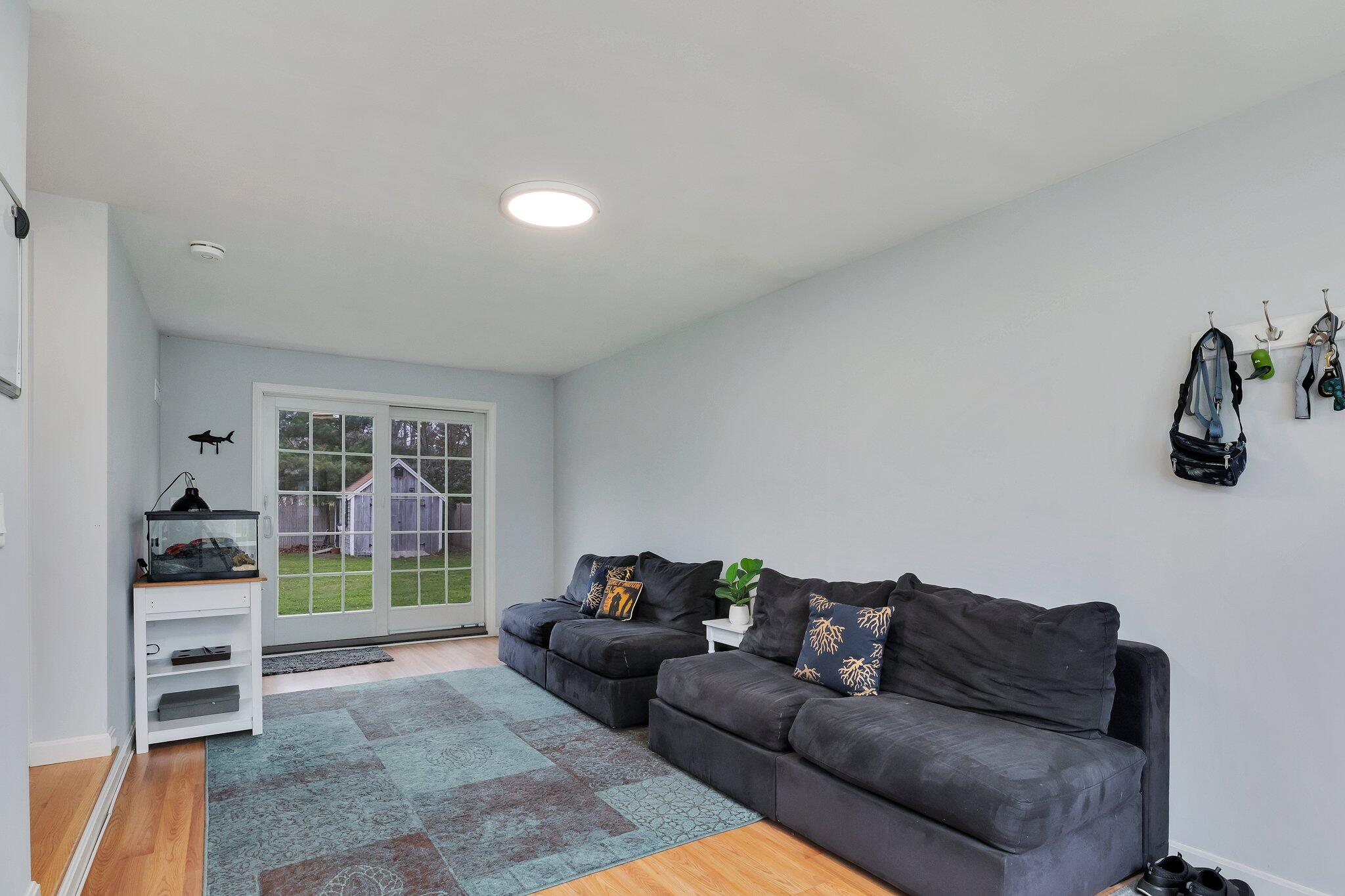 159 Sheaffer Road Centerville, MA 02632 - Photo 14 of 29 a living room with furniture and a large window