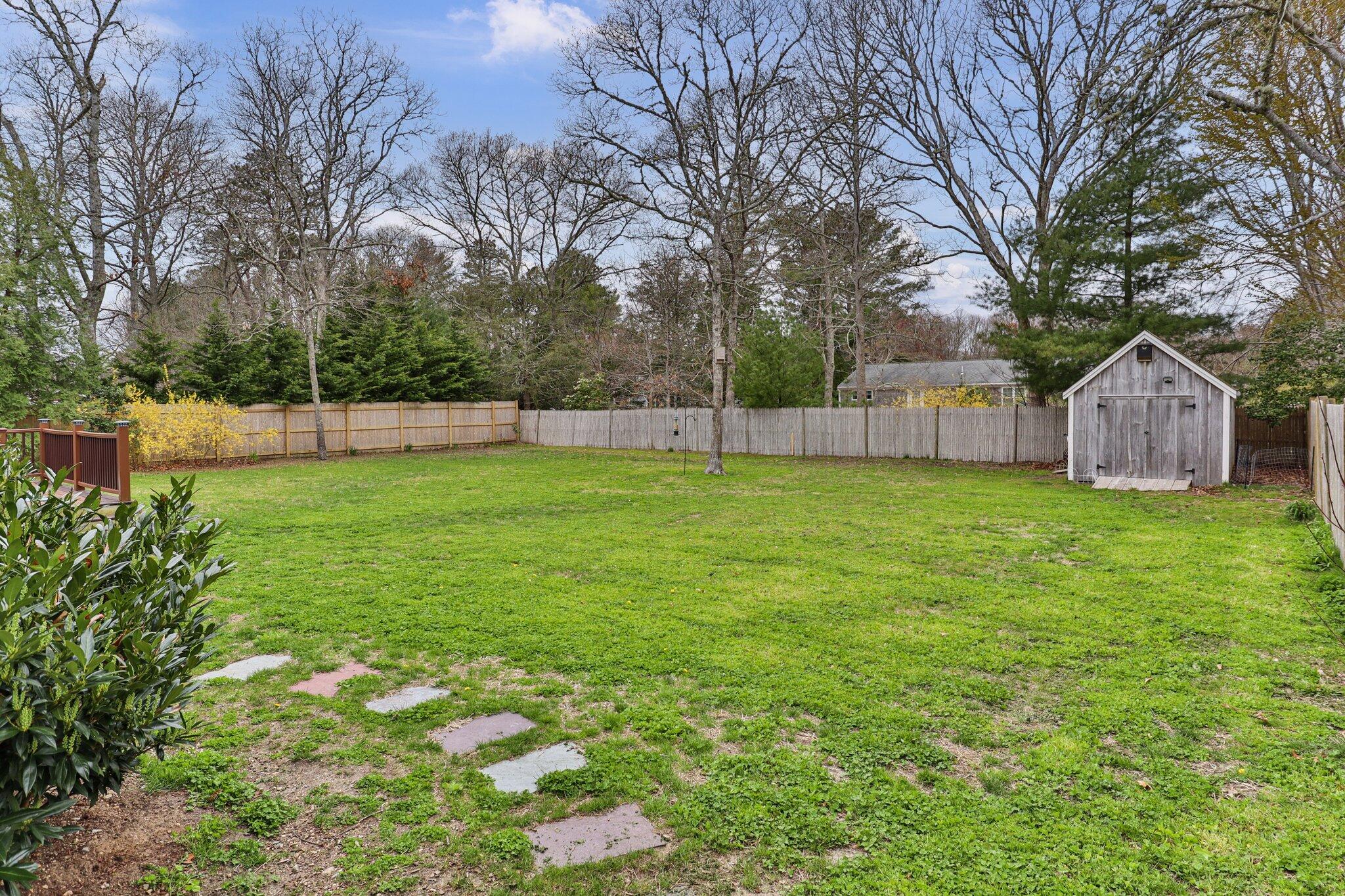 159 Sheaffer Road Centerville, MA 02632 - Photo 26 of 29 a view of a backyard with a small cabin
