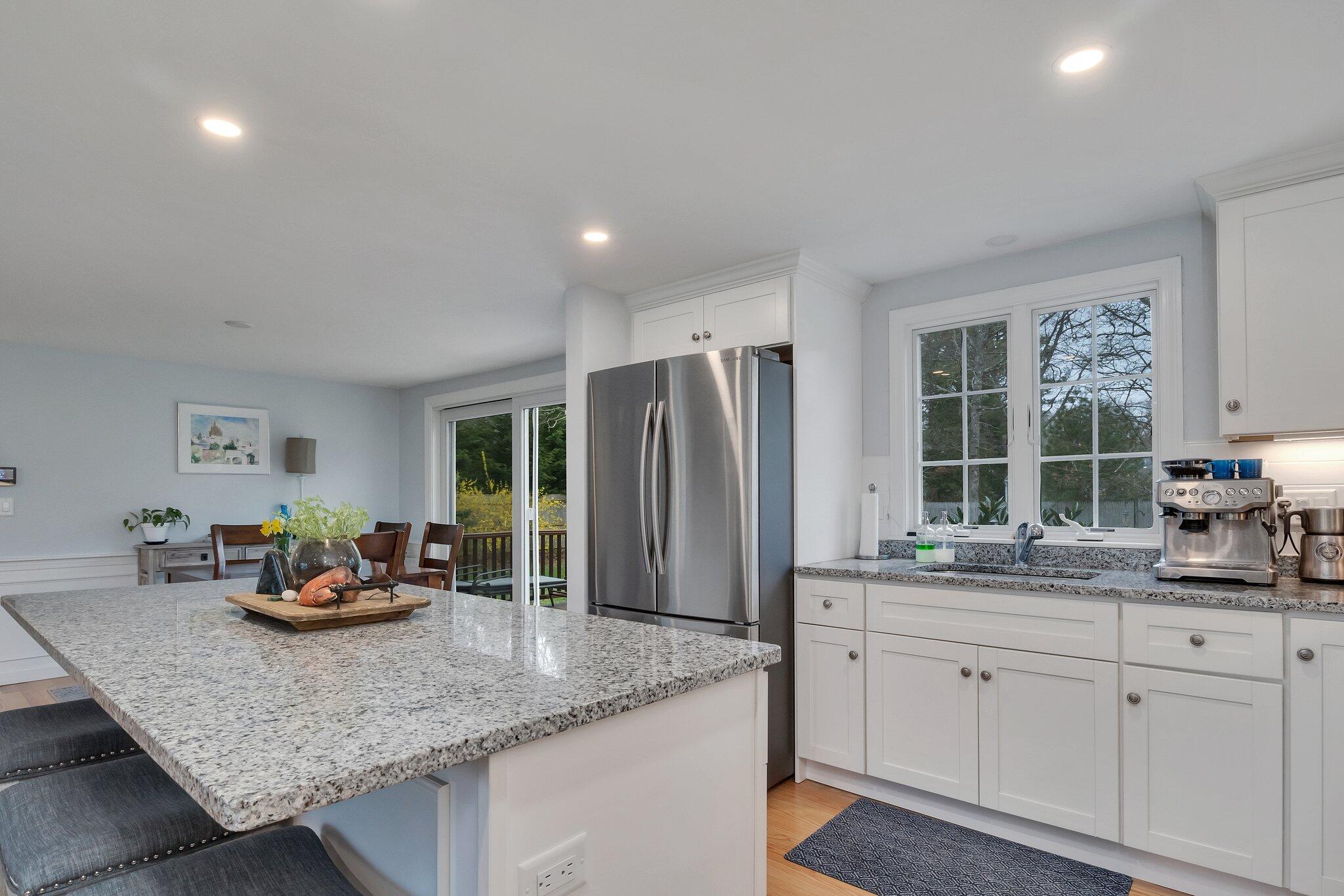159 Sheaffer Road Centerville, MA 02632 - Photo 5 of 29 a kitchen with granite countertop a sink and cabinets