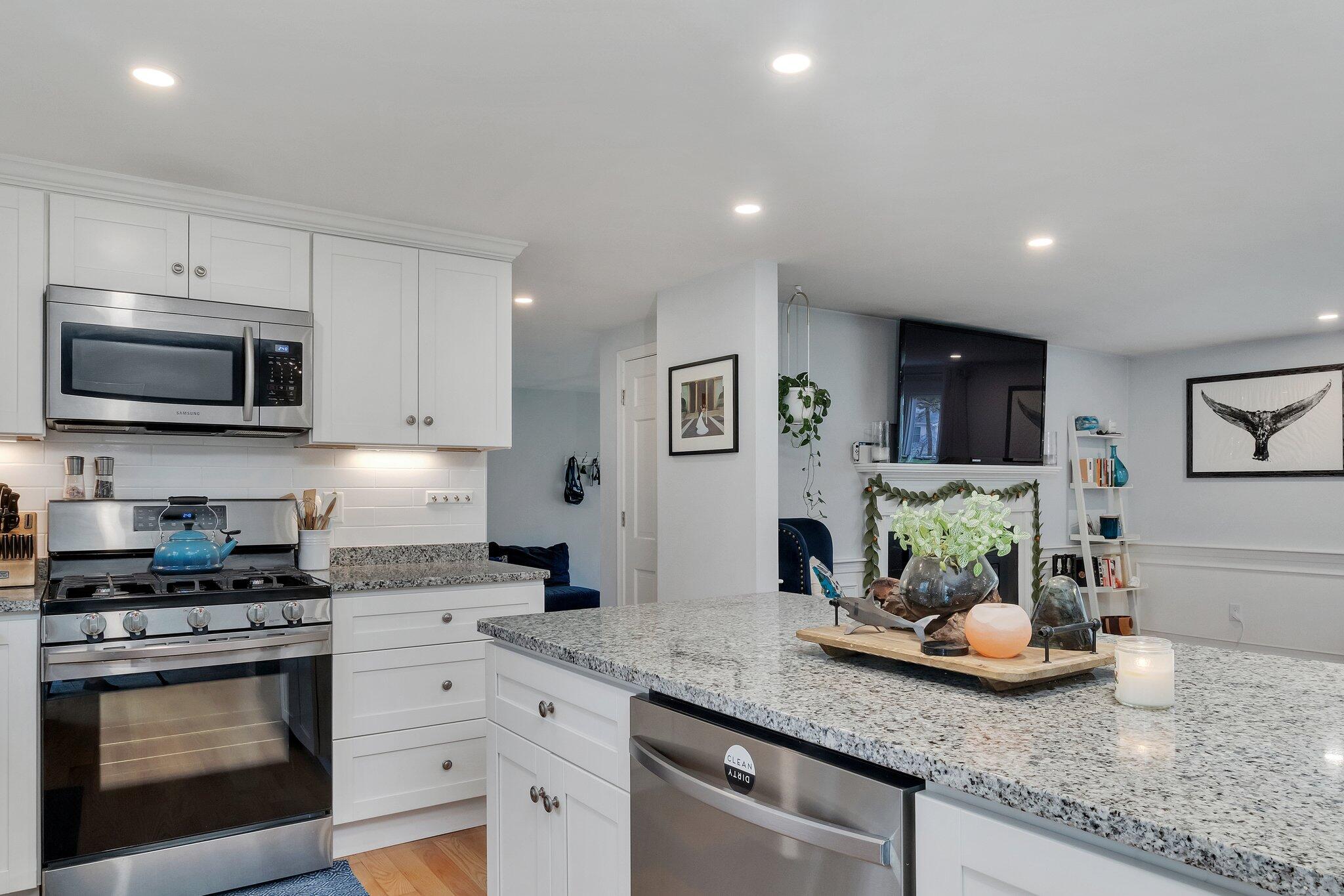 159 Sheaffer Road Centerville, MA 02632 - Photo 6 of 29 a kitchen with sink a stove and cabinets