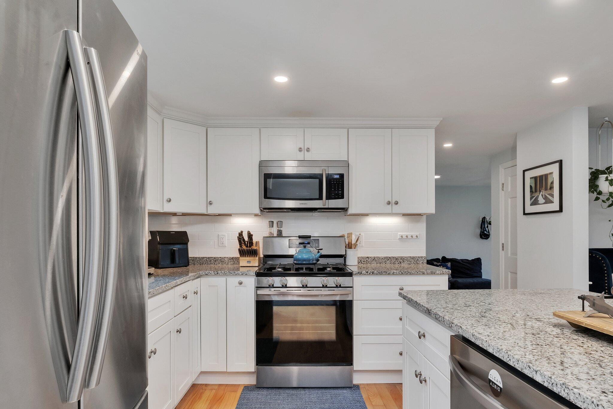 159 Sheaffer Road Centerville, MA 02632 - Photo 7 of 29 a kitchen with stainless steel appliances granite countertop a refrigerator sink and stove