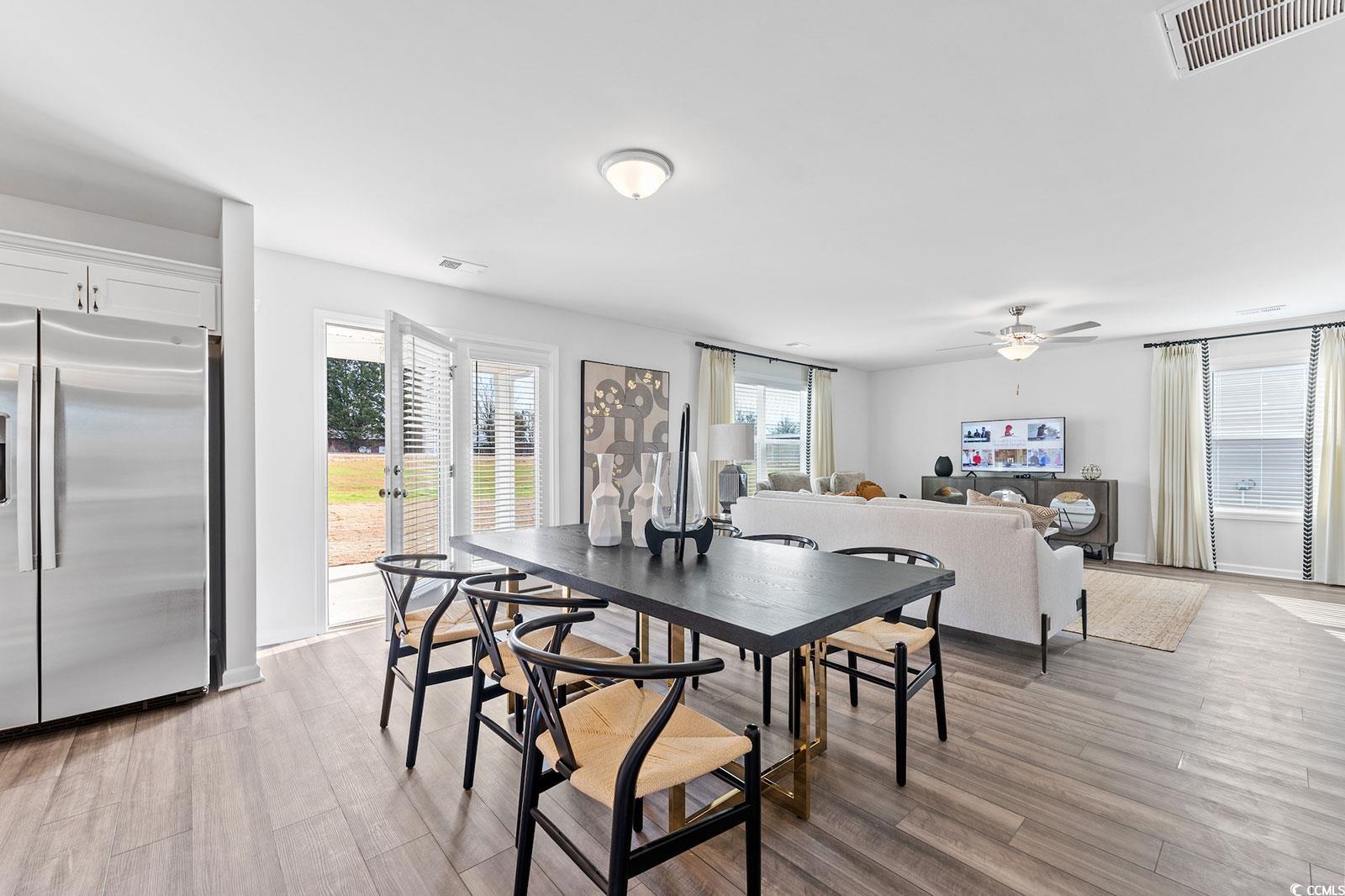 211 Sundrop Way Conway, SC 29526 - Photo 3 of 10 Dining room with light wood-style flooring and a ceiling fan
