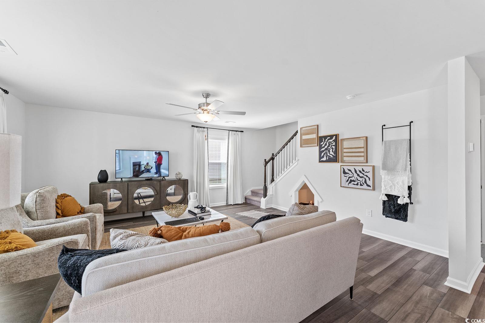 211 Sundrop Way Conway, SC 29526 - Photo 5 of 10 Living area with dark wood finished floors, a ceiling fan, and stairs