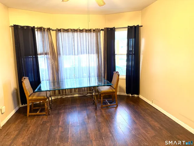 a view of a workspace with furniture and wooden floor