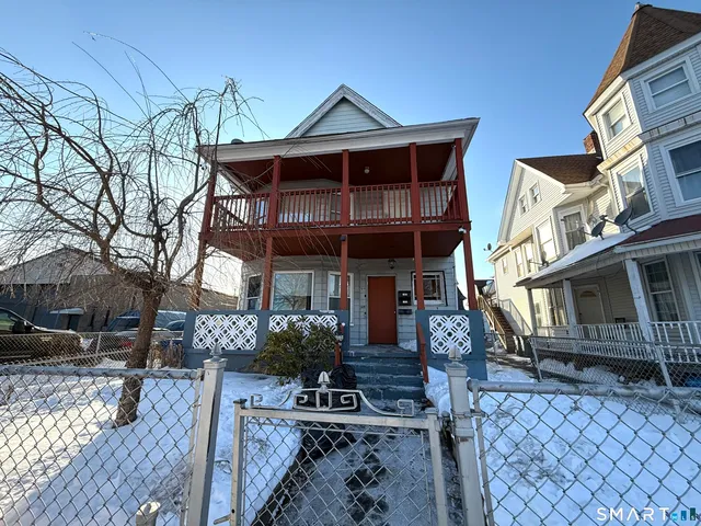 a front view of a house with chairs