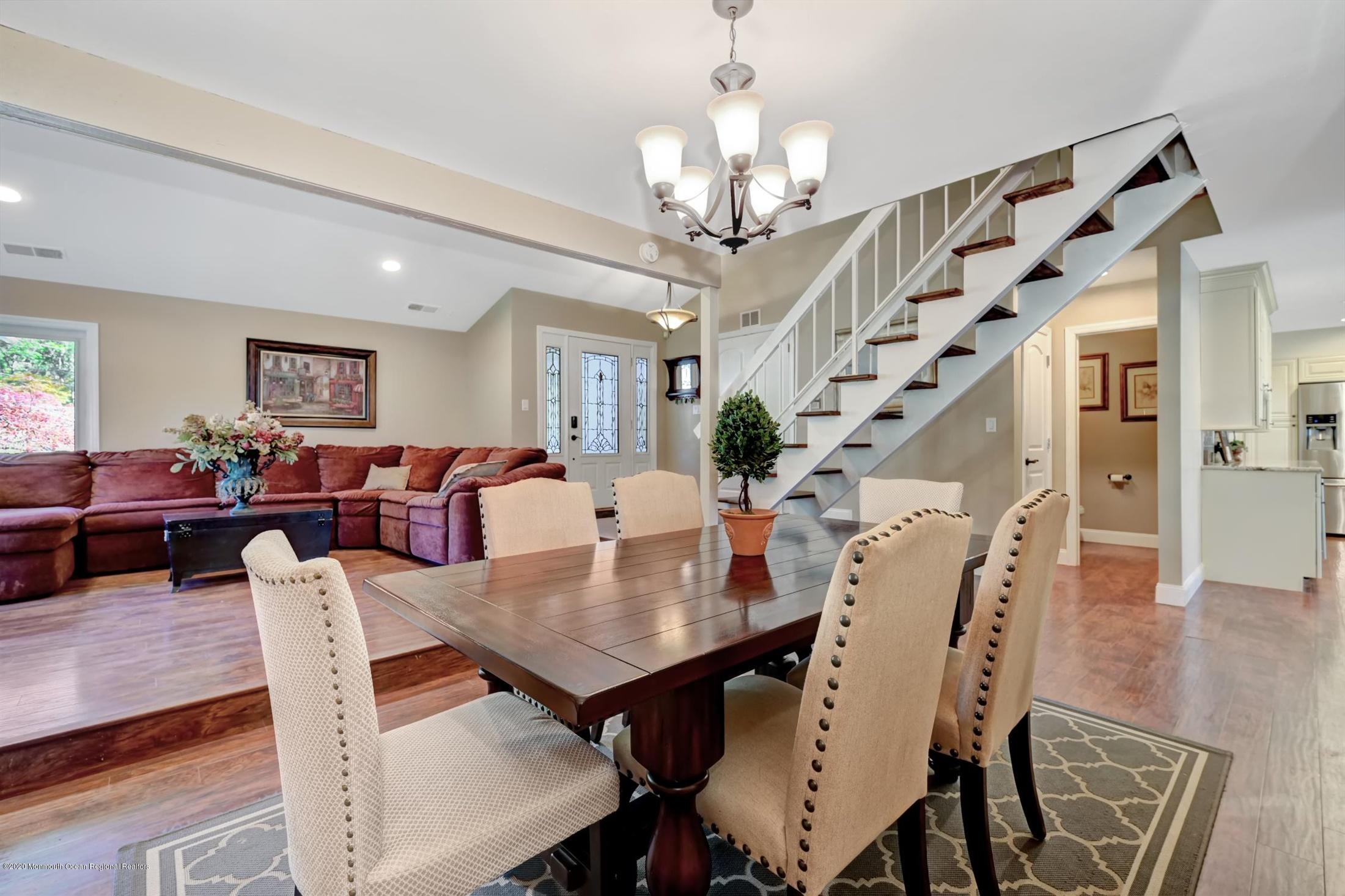 27 Sugar Bush Road Howell, NJ 07731 - Photo 14 of 46 a view of a dining room with furniture wooden floor and chandelier