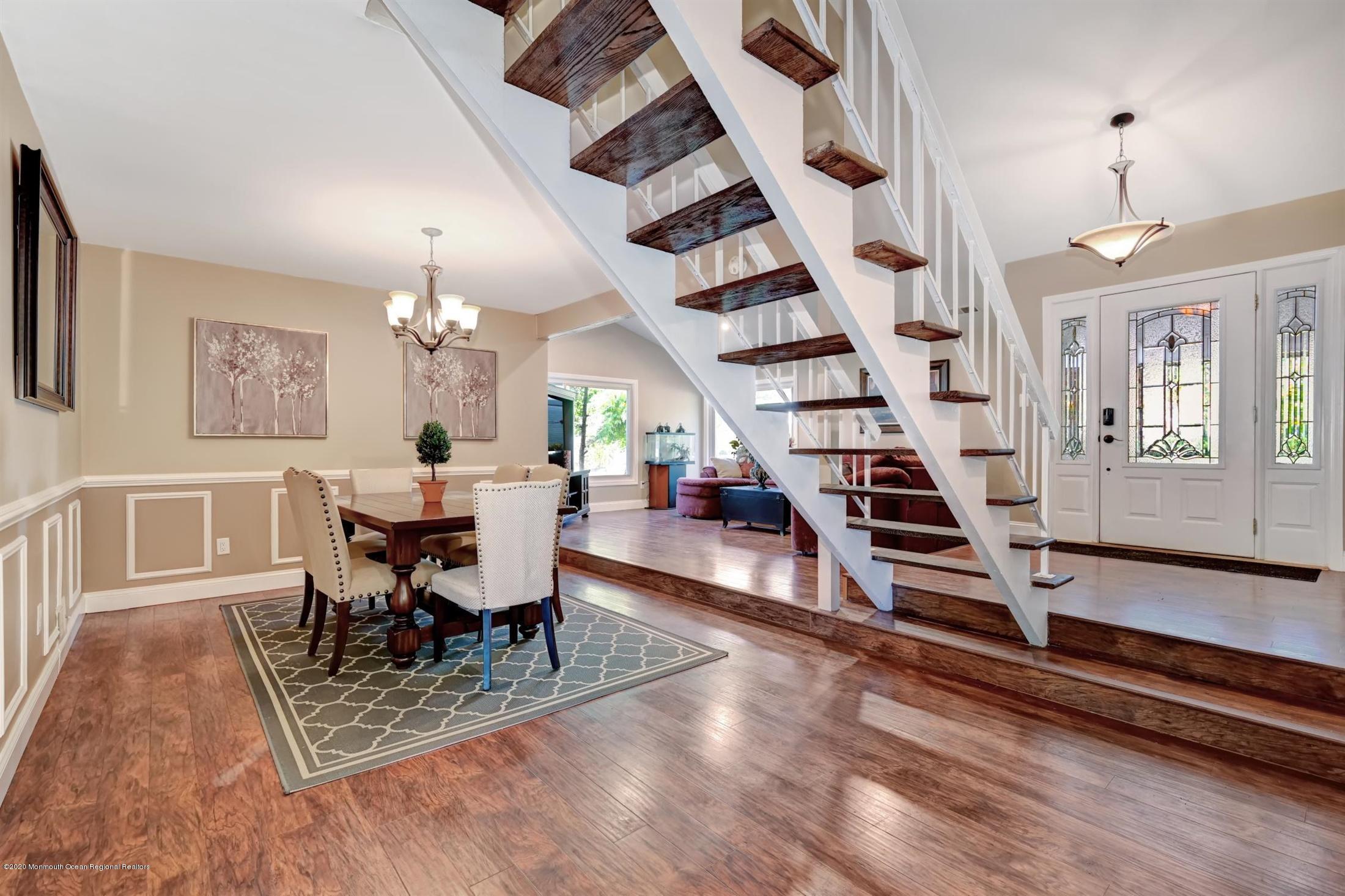 27 Sugar Bush Road Howell, NJ 07731 - Photo 15 of 46 a view of a dining room with furniture wooden floor and chandelier