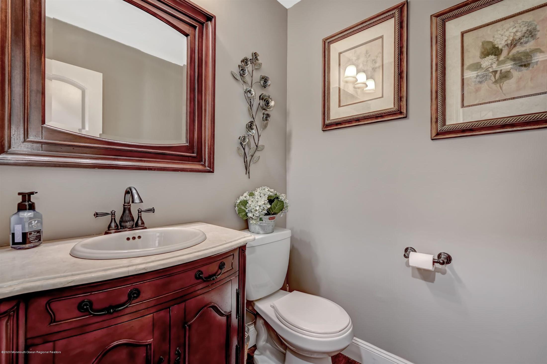27 Sugar Bush Road Howell, NJ 07731 - Photo 16 of 46 a bathroom with a toilet a sink and mirror